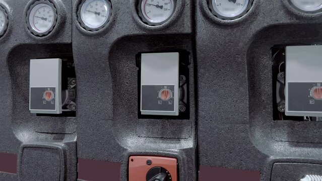 Thermometers to control water preheating in a home heating system and gas boiler temperature controller. Closeup. Shot in motion