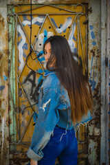 long-haired girl, with her back turned, looks at the camera