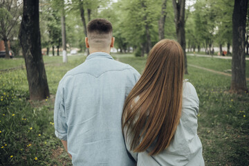 Fototapeta premium a couple in love walks in the park. rear view