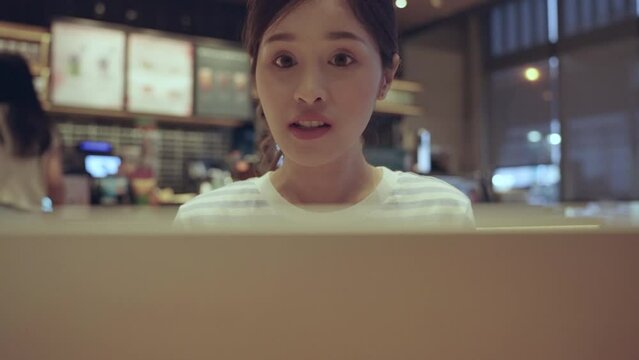 Young Asian freelance woman video conference with laptop computer anytime anywhere. Internet of things.