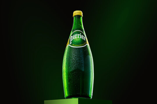 Bottle of Cold Perrier sparkling water with water drops. French brand of natural bottled mineral water Perrier. Tallinn, Estonia, May2022.