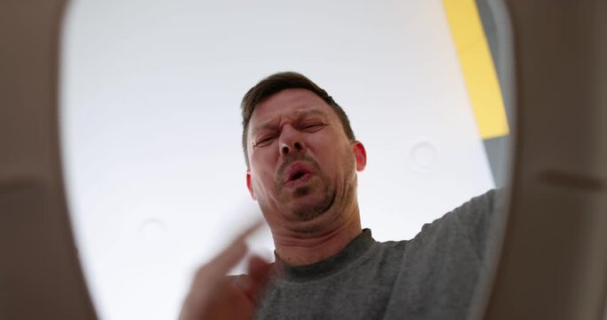 Man open toilet lid with strong smelly smell and cleans sewer