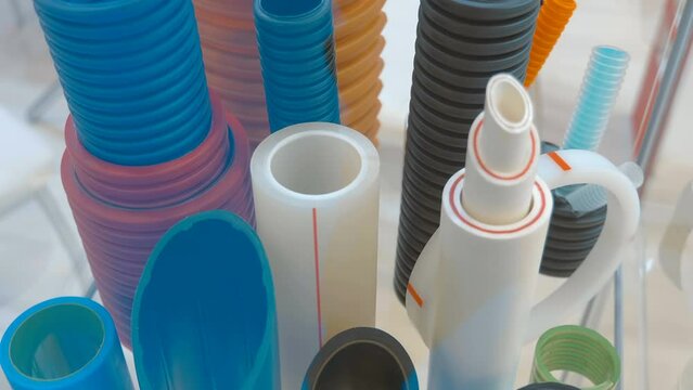 Samples of multilayer plastic pipes for cold and hot water supply, as well as for heating and sewerage at home. Closeup. Shot in motion