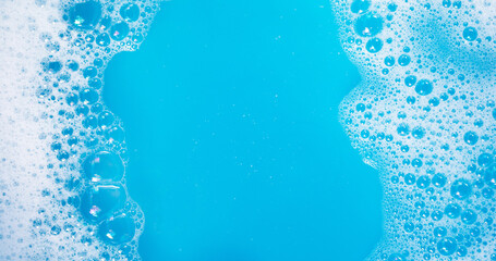 Detergent foam bubble on blue background.