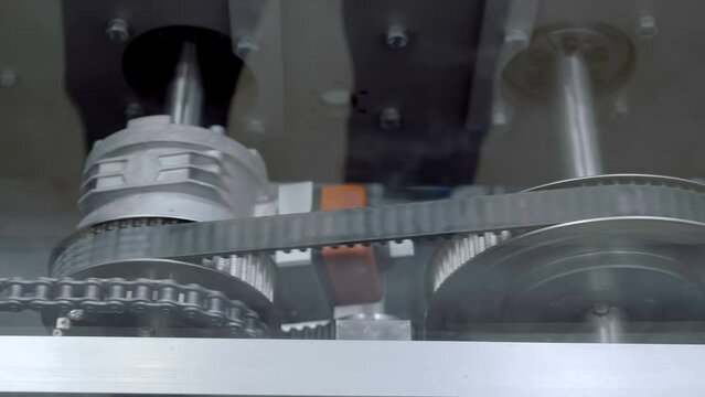 Movable elements, metal gears, drive belts, chains and conveyor elements in the operation of industrial equipment operate cyclically in automatic mode all the time. Closeup