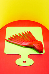 Abstract still life with red forks on a kitchen board