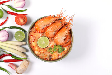 Tom yum kung spicy. Tom Yum kung in a bowl with ingredients on a white background, top view have copy space.