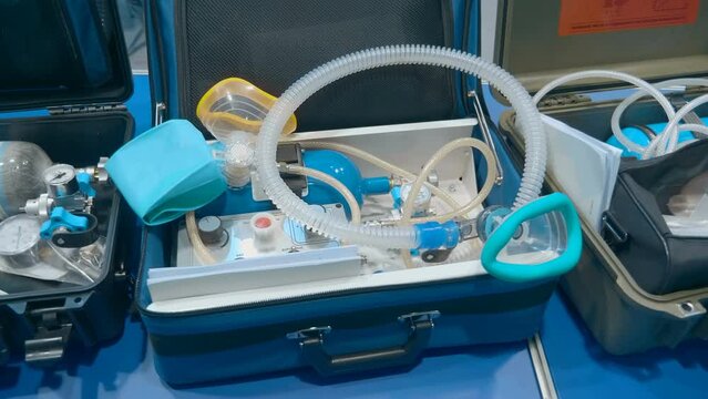 New samples of portable ventilators (individual lung ventilation) in shockproof cases at the medical equipment exhibition. Close up. Shot in motion
