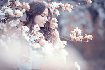 happy girl dreaming in a blooming garden, fresh tenderness spring woman in flowers