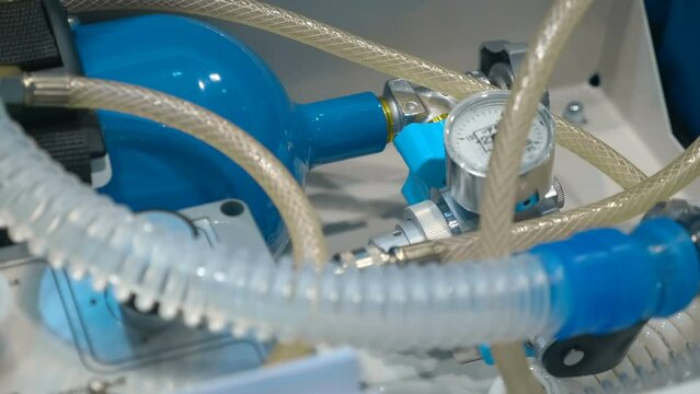 New samples of portable ventilators (individual lung ventilation) in shockproof cases at the medical equipment exhibition. Close up. Shot in motion
