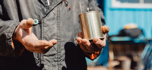 Dirty hands homeless old poor man with canned food donation. Concept global crisis, economic...