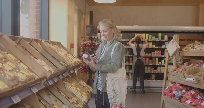Mature Female Customer Buying Groceries in Supermarket Store