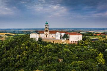Pannonhalma, Hungary - Aerial view of the beautiful Millenary Benedictine Abbey of Pannonhalma (Pannonhalmi Apatsag) with blue sky and green summer foliage at summertime
