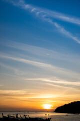 Beautiful sunset color sky between blue and yellow with fisherman's boat vertical scenery in Koh Lipe, Thailand