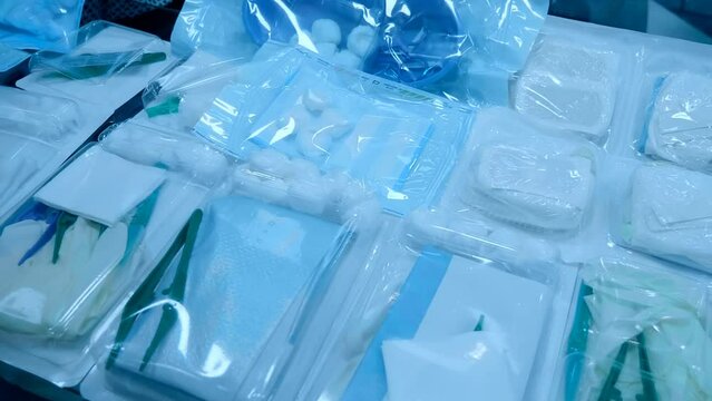 A set of materials for the treatment of wounds. Sterile disposable set with tray, power clip, gauze and cotton balls. Closeup. Shot in motion
