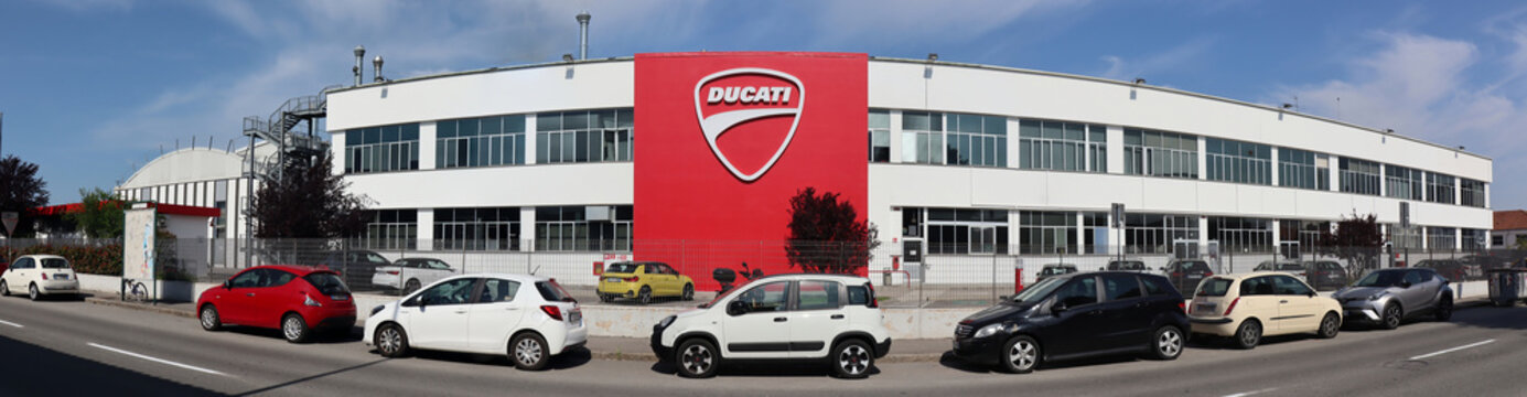 Bologna, Borgo Panigale - Italy - May 5, 2022: Panoramic view of the Headquarters of Ducati with big logo on the wall. Ducati is a famous Italian motorcycle manufacturing company. Bologna, Italy