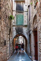 Old streets, architecture. Old facades and red tiled roofs. Vacation in the south of Europe. Exterior of buildings. Old style.