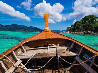 Wooden fishery travel boat on sea shore turquoise water blue sky