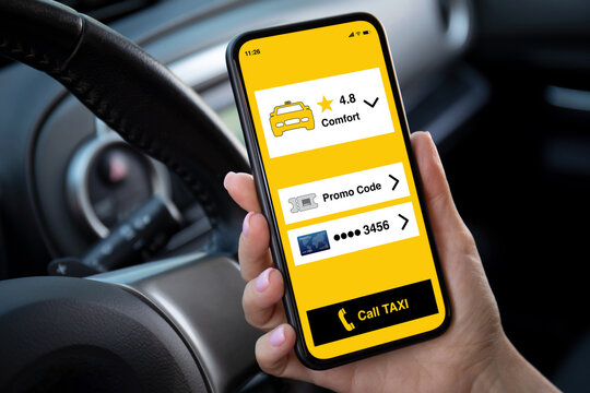 female hand holding phone with application call taxi on screen