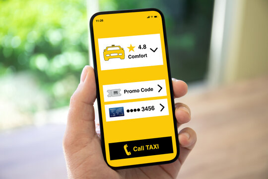 man hand holding phone with application call taxi on screen
