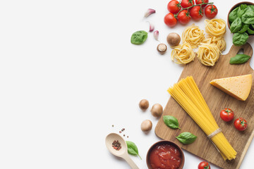 Culinary background with ingredients for cooking pasta with tomatoes on a white background