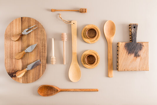 various kitchen utensils made of wood on a pastel background. top view. flat lay.