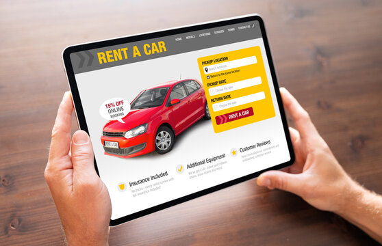 Person looking at car rental website on tablet computer to rent a car