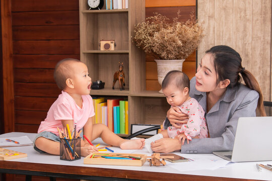 Beautiful Asian Mother Confuse Multi Task While Work At Home, Women Work From Home Fussy Taking Care Children In Quarantine Social Distance During Covid-19 Crisis, Worried Single Mom With Chaotic Kids