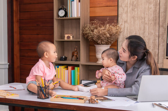 Beautiful Asian Mother Confuse Multi Task While Work At Home, Women Work From Home Fussy Taking Care Children In Quarantine Social Distance During Covid-19 Crisis, Worried Single Mom With Chaotic Kids