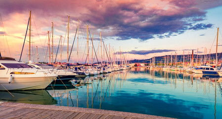 Impressive summer sunset in Izola port. Exciting evening on Adriatic Sea with many luxury yacht....
