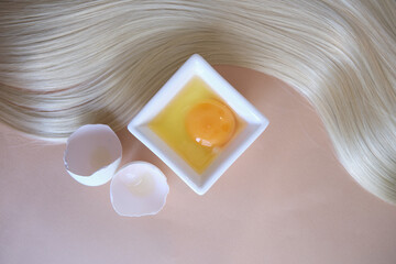 lock of silk hair and an egg, the concept of homemade shampoo, the benefits of eggs for hair