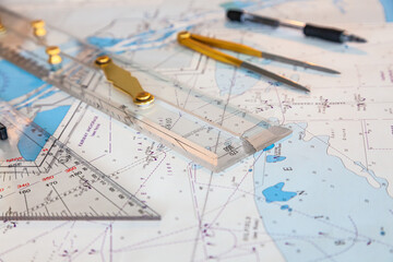Navigation ship chart for building a sailing route. Plotter, divider, ruler and pen on a map. - obrazy, fototapety, plakaty