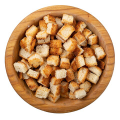 Bread rusks. Fried pieces of bread in a wooden bowl isolated on white background. Caesar salad ingredients. Delicious snacks. Top view.