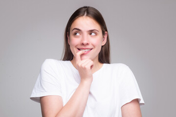 Fototapeta premium Beautiful woman with questioning gesture. Girl shrugging shoulders, doubts.