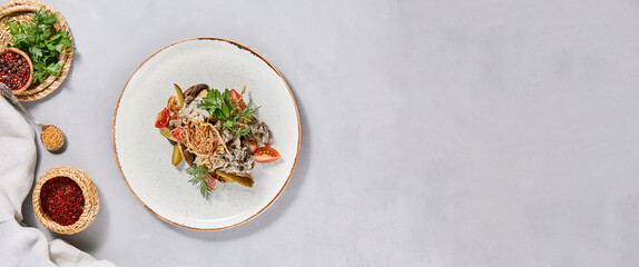 Traditional russian food - beef stroganoff with mashed potatoes and creamy gravy. Beef stroganoff with crispy onion on ceramic plate. Meat ragout with mashed, mushrooms and greens on stone background.