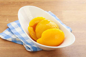 Sweet canned peaches with syrope