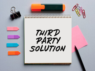 The message third party solution written on a notebook on business office desktop. Business consulting, assistance and mediation concept.