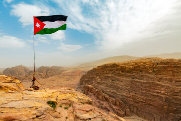 Jordan flag waving on a sunny and windy day in Petra landscape, Jordan