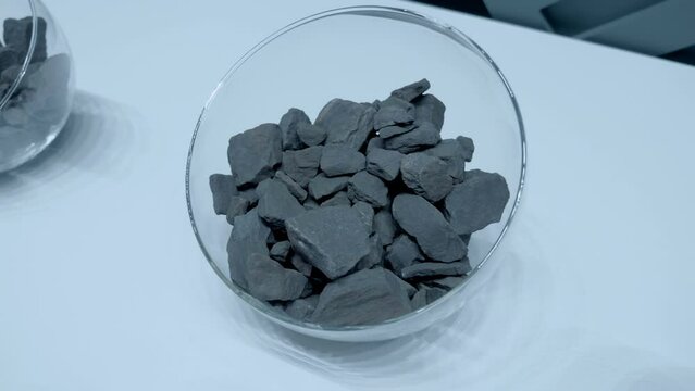 Iron ores are rocks and minerals from which metallic iron can be extracted. Iron ore is the raw material used to make cast iron, which is then used to make steel. Closeup. Shot in motion