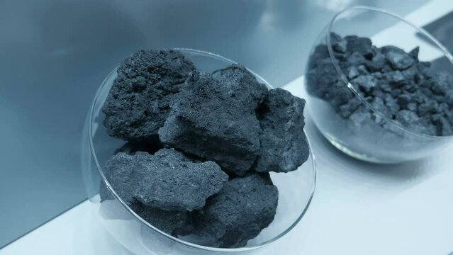 Iron ores are rocks and minerals from which metallic iron can be extracted. Iron ore is the raw material used to make cast iron, which is then used to make steel. Closeup. Shot in motion