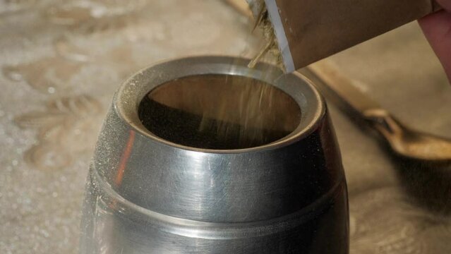 Yerba mate is poured into a cup on the table 