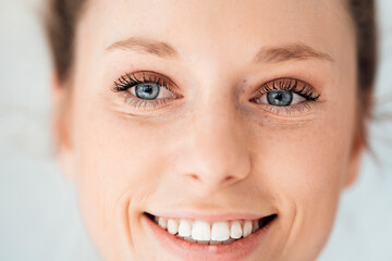 Young smiling businesswoman with gray eyes