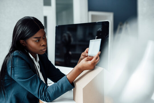 Architect examining solar panel model at desk