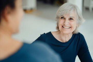 Smiling businesswoman with colleague sitting in office