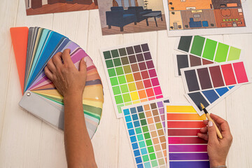 office workers consider a palette of colors that are selected for the design of a new kitchen.