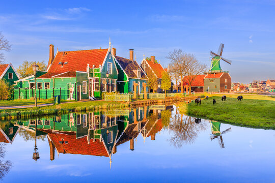 Zaanse Schans village, Netherlands. Dutch windmill and traditional house at sunrise.
