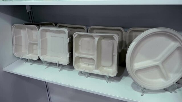 Sets of new paper trays of various shapes and capacities for a single meal. Shot in motion