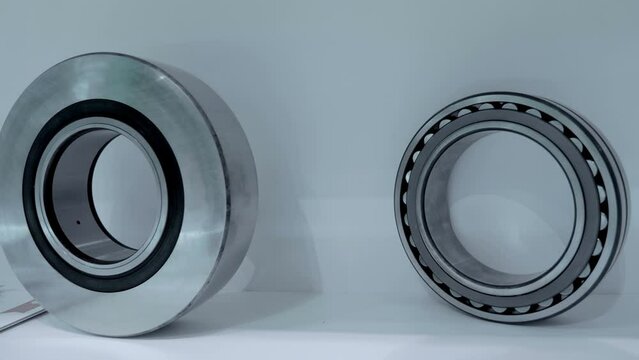 New industrial bearings of various types and sizes are presented at the machine tool exhibition. Close up. Shot in motion