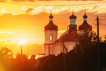 Fototapeta premium Yurovichi, Belarus. , Big Sun Above Jesuit Collegium Complex. Yurovichi, Belarus. Big Sun Above Jesuit Collegium Complex