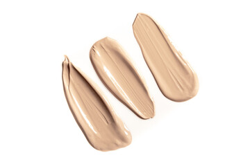 Foundation with smears as a sample on a white background. Makeup cosmetics. Tone cream. Concealer texture.